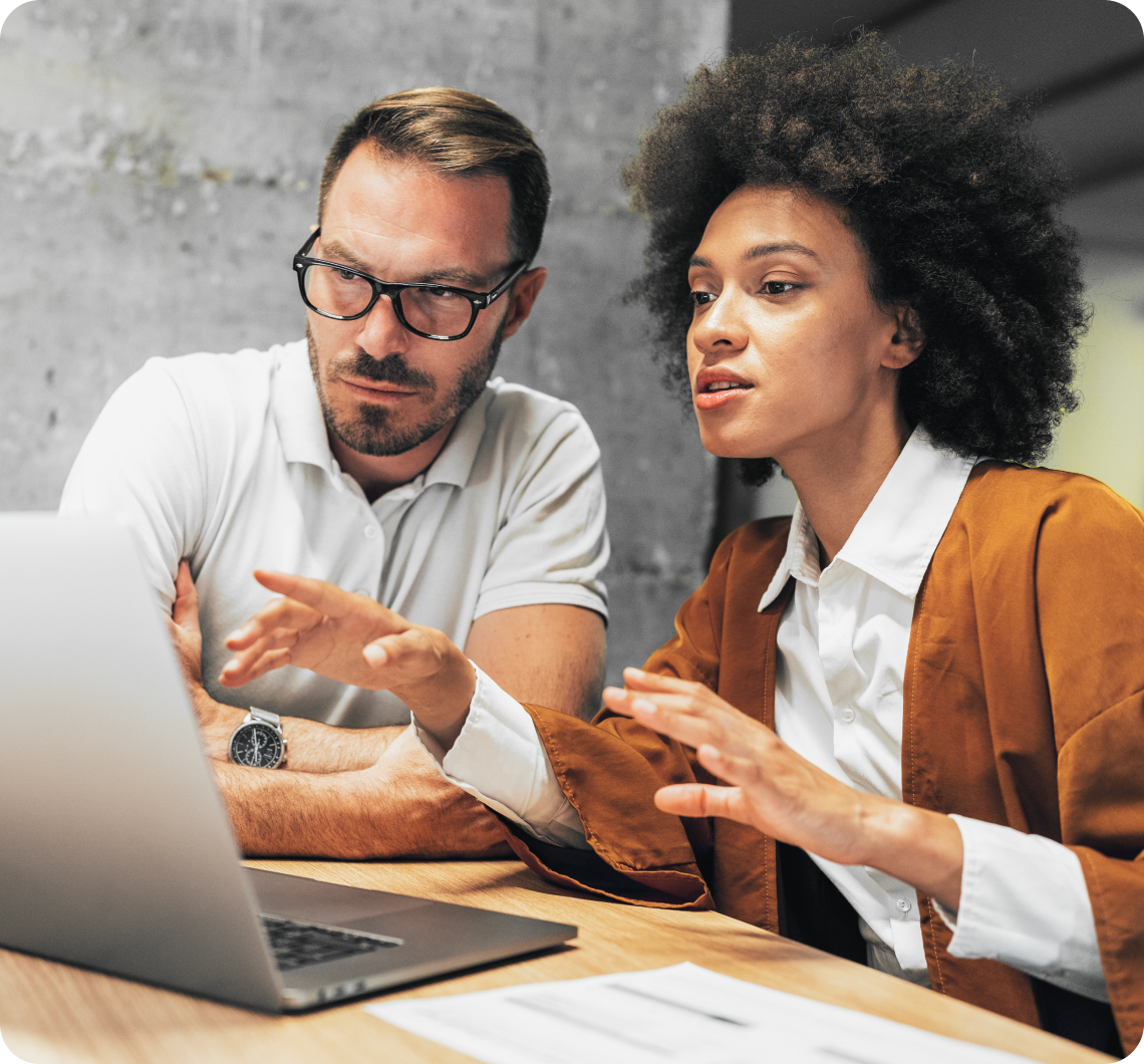 Two person discussing on a laptop
