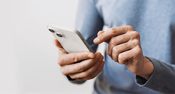 A man typing on a cellphone